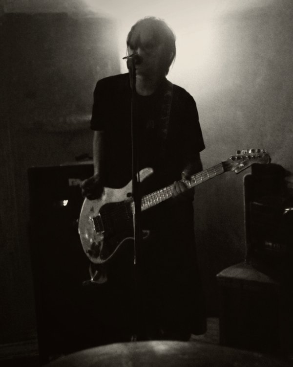 Yigit Erkoc performing live with guitar and microphone